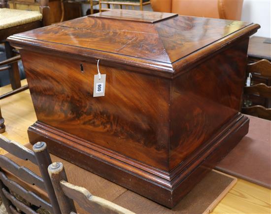 An early Victorian flame mahogany sarcophagus shaped wine cooler, with rectangular top enclosing a tray, on moulded plinth base, 72cm